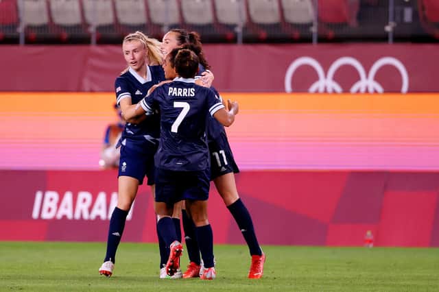 KASHIMA, JAPAN - JULY 27: Caroline Weir #11 of Team Great Britain celebrates with Leah Williamson #16 and teammates after scoring their side's first goal during the Women's Group E match between Canada and Great Britain. (Photo by Atsushi Tomura/Getty Images)
