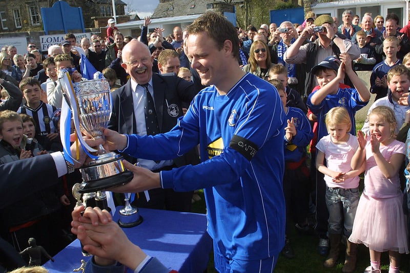 Captain Darren Brookes receives the NCEL Premier Division championship trophy