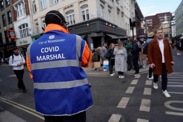 A 'Covid Marshall' from Westminster City Council ensures people are following the Covid restricitions as pubs and hospitality venues reopen across England (Picture: Getty Images)