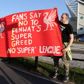 Fans hold up a protest banner against Liverpool FC and the European Super League outside Elland Road before the Reds took on Leeds United.