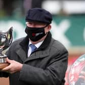 Sir Alex Ferguson collects the trophy after winning the Betway Bowl Chase to complete a hat-trick of wins in the first three races on Liverpool NHS Day of the 2021 Randox Health Grand National Festival at Aintree Racecourse, Liverpool.