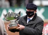 Sir Alex Ferguson collects the trophy after winning the Betway Bowl Chase to complete a hat-trick of wins in the first three races on Liverpool NHS Day of the 2021 Randox Health Grand National Festival at Aintree Racecourse, Liverpool.