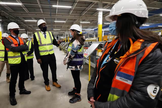 John Boumphrey, Amazon UK Country Manager (left) and Kwasi Kwarteng, BEIS Secretary, speak with HR business partner, Lucy Baker and apprentice Kathryn Sissons (right) at Amazon's new fulfilment centre in Gateshead as the company announces the creation of more than 10,000 new permanent jobs in 2021 (PA).