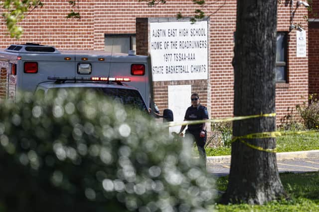 A member of the Knoxville police forensics team works the scene of a shooting at Austin-East Magnet High School in Knoxville, Tennessee (AP)