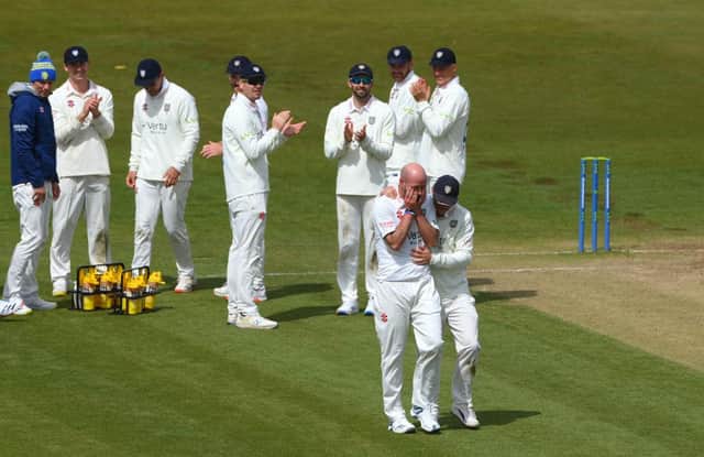 Durham bowler Chris Rushworth is congratulated by captain Scott Borthwick (r) and team-mates after taking the wicket of Worcestershire batsman Jack Haynes for his 528th first class wicket for Durham, beating the previous record set by Graham Onions.
