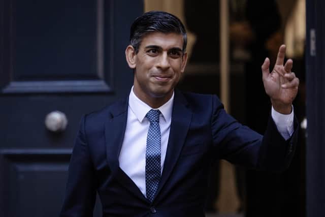 New Conservative Party leader and incoming prime minister Rishi Sunak waves as he leaves the Conservative Party Headquarters yesterday