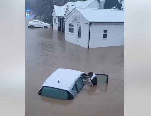 Video shows heroic pub landlord pull woman from car in dramatic flood rescue during extreme weather