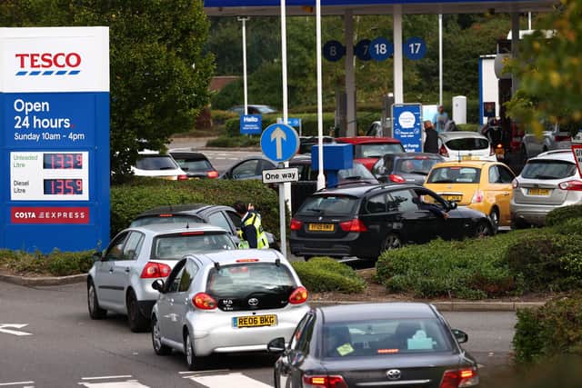 Queues of cars snake round the road leading to this Tesco petrol station. (PHOTO BY: Adrian Dennis/Getty Images)