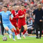 Phil Foden of Manchester City gets away from Jordan Henderson and James Milner. (Photo by Michael Regan/Getty Images)