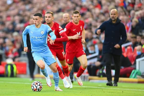 Phil Foden of Manchester City gets away from Jordan Henderson and James Milner. (Photo by Michael Regan/Getty Images)
