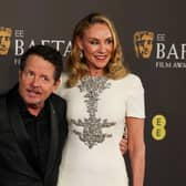 Canadian actor Michael J Fox, left, and his wife US actress Tracy Pollan pose on the red carpet upon arrival at the Baftas. (Picture: Adrian Dennis/AFP via Getty Images)