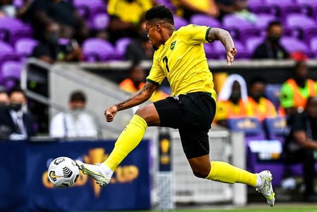 Jamaica's Leon Bailey jumps for the ball during the Gold Cup Prelims football match between Jamaica and Suriname at the Exploria Stadium in Orlando, Florida.