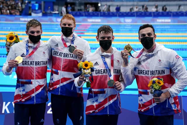 Great Britain's Duncan Scott, Tom Dean, Matthew Richards and James Guy celebrate gold in the Men's 4x200 freestyle relay (PA)