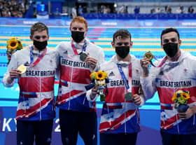 Great Britain's Duncan Scott, Tom Dean, Matthew Richards and James Guy celebrate gold in the Men's 4x200 freestyle relay (PA)
