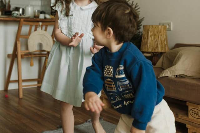 A Girl and Boy Playing Inside the House