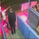 CCTV caught a thug smashing a bottle over a bouncer's head early one morning in Wigan