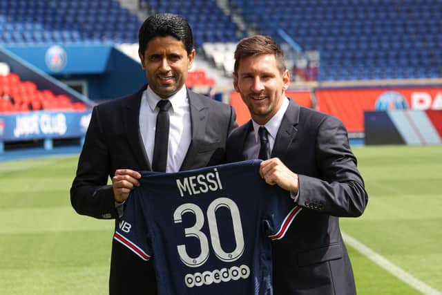 Lionel Messi poses with his PSG jersey next to President Nasser Al Khelaifi. (Photo by Sebastien Muylaert/Getty Images)