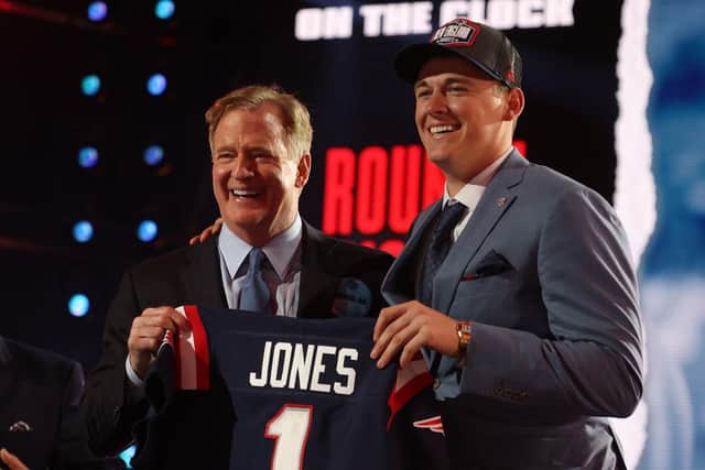 Mac Jones poses with NFL Commissioner Roger Goodell onstage after being selected 15th by the New England Patriots.