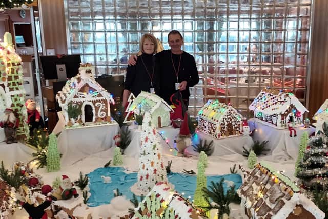 Brian Launder, 75, and his wife Carole, 70, on board the MS Maud beside a Christmas display before the ship was hit by a storm.