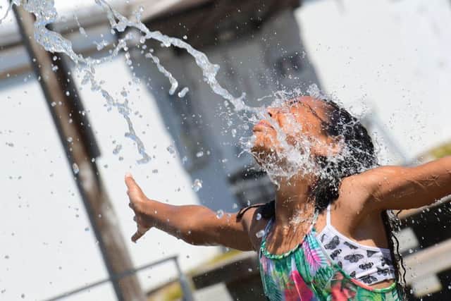 Kids have made good use of sprinklers and water features in Richmond, British Columbia, as schools and Covid-vaccination centres were forced to close (Picture: Getty Images)