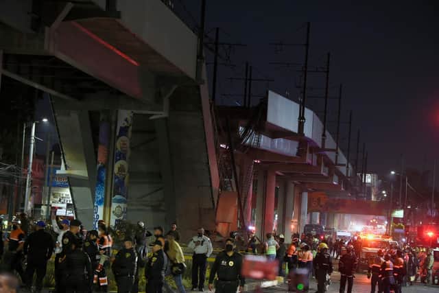 Rescue workers gather at the scene after an overpass for a metro partially collapsed in Mexico City (Photo by ALFREDO ESTRELLA / AFP) (Photo by ALFREDO ESTRELLA/AFP via Getty Images)