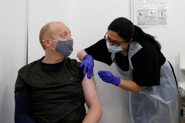 Martin Gillibrand, 45, receives an AstraZeneca vaccination at a Boots pharmacy in London, England (Photo by Hollie Adams/Getty Images)