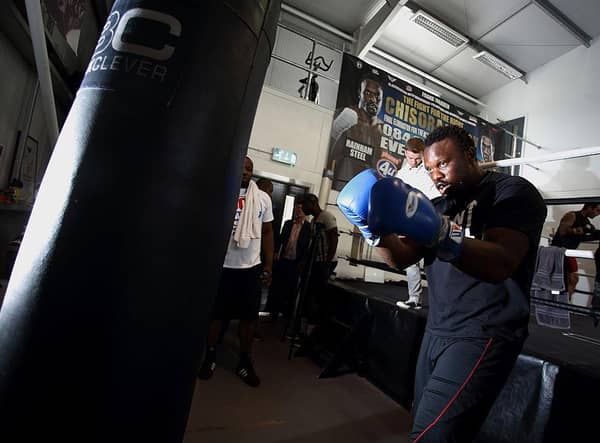 Derek Chisora trains on a punchbag. The fighter has a new trainer in his camp.