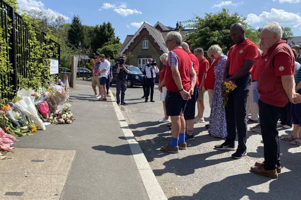 Members of Wimbledon Common Golf Club hold a minute's silence outside the gates of  Study Preparatory School in Wimbledon, south-west London, after a Land Rover crashed into the girls' prep school building on the last day of term. An eight-year-old girl was killed and 10 people were taken to hospital following the incident. Photo: Harry Stedman/PA Wire