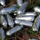 Canisters of nitrous oxide, or laughing gas, discarded by the side of a road. PIC: Gareth Fuller/PA Wire