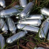 Canisters of nitrous oxide, or laughing gas, discarded by the side of a road. (Image: Gareth Fuller/PA Wire)
