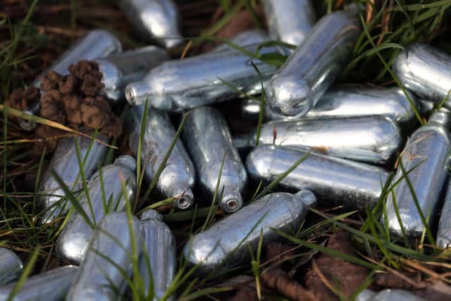 Canisters of nitrous oxide, or laughing gas, discarded by the side of a road. (Image: Gareth Fuller/PA Wire)