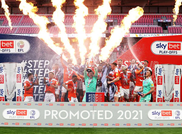 Chris Maxwell of Blackpool lifts the Sky Bet League One Play-off Trophy as his team mates celebrate following victory in the Sky Bet League One Play-off Final match between Blackpool and Lincoln City at Wembley Stadium on May 30, 2021 in London, England. (Photo by Catherine Ivill/Getty Images)