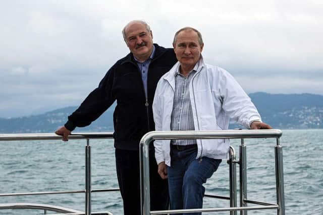 Russian President Vladimir Putin and Belarusian leader Alexander Lukashenko pose on a boat during a boat trip on the Black Sea in May.