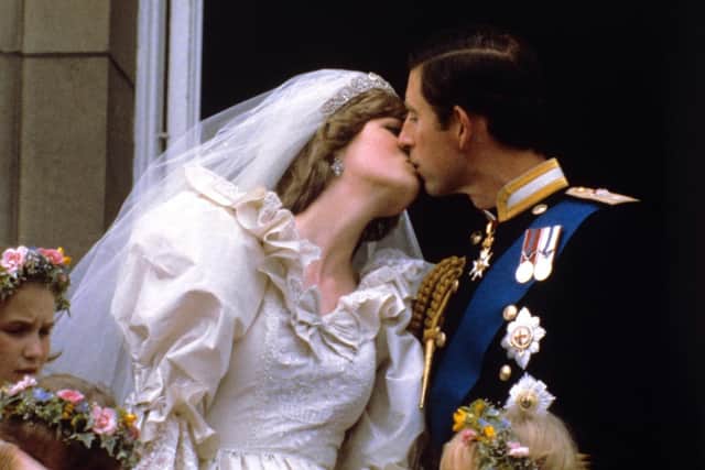 The newly married Prince and Princess of Wales kissing on the balcony of Buckingham Palace after their wedding ceremony (Photo: PA Wire/PA Images)