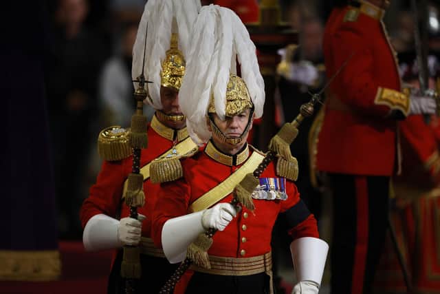 The changing of the guard is conducted as members of the public view the coffin of Queen Elizabeth II, lying in state on the catafalque in Westminster Hall, at the Palace of Westminster, London, ahead of her funeral on Monday. Picture date: Saturday September 17, 2022. PA Photo: Chip Somodevilla/PA Wire