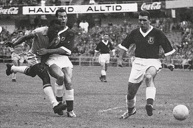 17-year-old Brazilian forward Pele (L) kicks the ball past two Welsh defenders during the World Cup quarterfinal soccer match between Brazil and Wales 19 June 1958 in Goteborg. Pele scored the only goal of the match to help Brazil advance to the semifinals.  
AFP PHOTO/INTERCONTINENTALE (Photo credit should read STAFF/AFP via Getty Images)