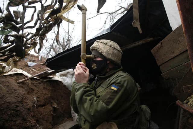 TOPSHOT - A Ukrainian serviceman stands guard at a position on the frontline with Russia backed separatists near small city of Marinka, Donetsk region on April 12, 2021. - Ukrainian soldiers have been killed in clashes with pro-Russia separatists in Ukraine's war-torn east, its military said on April 12, 2021, as Kiev again accused Moscow of massing tens of thousands of soldiers on its border. (Photo by STR/AFP via Getty Images)