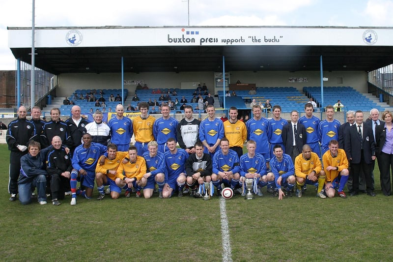Buxton's squad and directors with the league and cup trophies in 2006.