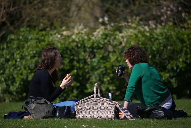 The warmer weather is set to coincide with the lifting of Covid restrictions around the UK (Photo: HOLLIE ADAMS/AFP via Getty Images)