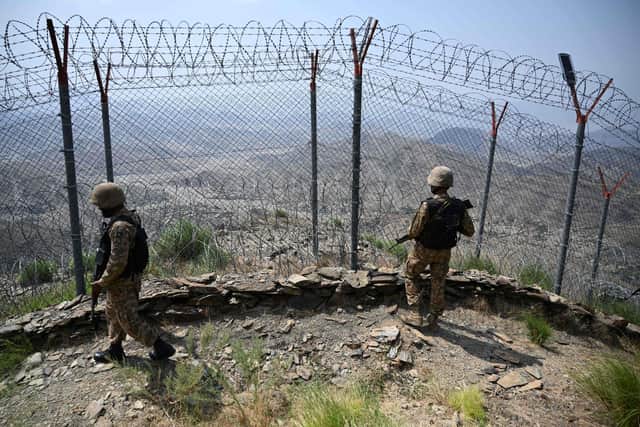 Pakistani troops patrol along Pakistan-Afghanistan border fence in the Khyber district of the Khyber Pakhtunkhwa province on August 3, 2021. (Photo AFP via Getty Images)
