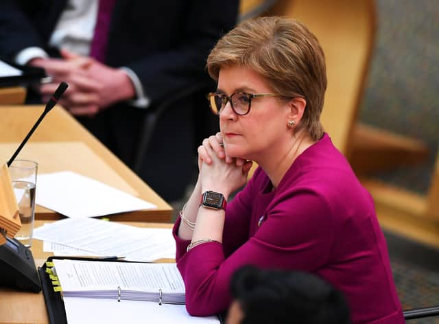 Nicola Sturgeon announced the rule on wearing face coverings on public transport and some other settings would stay in place. (Picture: Andy Buchanan/PA)