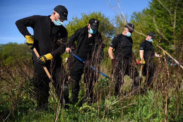 Police officers search the grassland near an address in Sunshine Corner Avenue, Aylesham, Kent in connection with the murder of PCSO Julia James (PA)