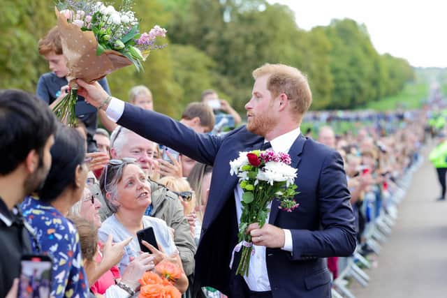 Prince Harry, Duke of Sussex receives flowers from the crowds at Windsor Castle on September 10. Picture: Chris Jackson/Getty Images.