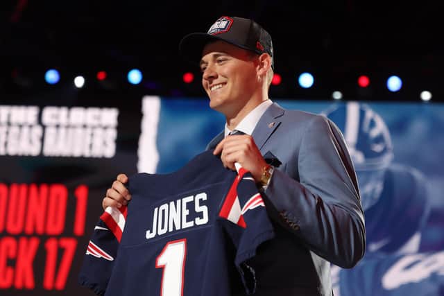 Mac Jones poses onstage after being selected 15th by the New England Patriots during round one of the 2021 NFL Draft at the Great Lakes Science Center on April 29, 2021 in Cleveland, Ohio. (Pic: Getty Images)