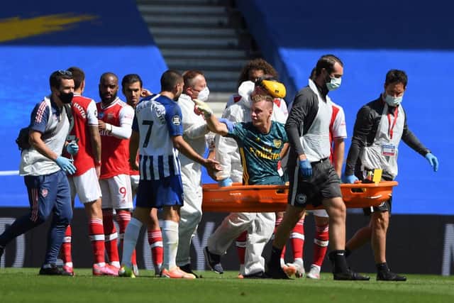 Arsenal's German goalkeeper Bernd Leno (on stretcher) remonstrates with Brighton's French striker Neal Maupay after the keeper was injured. Maupay received online abuse after the incident.