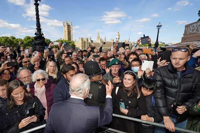 King Charles III meets members of the public in the queue along the South Bank, near to Lambeth Bridge, London, as they wait to view Queen Elizabeth II lying in state