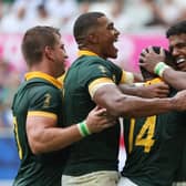South Africa's Grant Williams (second right) celebrates with teammates after scoring the team's seventh try in the win over Romania. (Photo by ROMAIN PERROCHEAU/AFP via Getty Images)