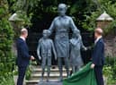 Britain's Prince William, Duke of Cambridge (L) and Britain's Prince Harry, Duke of Sussex unveil a statue of their mother, Princess Diana at The Sunken Garden in Kensington Palace, London on July 1, 2021, which would have been her 60th birthday. - Princes William and Harry set aside their differences on Thursday to unveil a new statue of their mother, Princess Diana, on what would have been her 60th birthday. (Photo by Dominic Lipinski / POOL / AFP) (Photo by DOMINIC LIPINSKI/POOL/AFP via Getty Images)