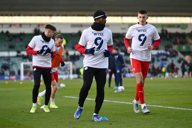 Wigan Athletic players warm up wearing number 9 shirts in support of Charlie Wyke. (Photo by Dan Mullan/Getty Images)
