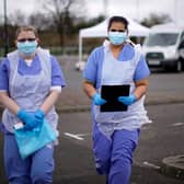 NHS nurses wait for the next patient at a drive through Coronavirus testing site in a car park (Photo by Christopher Furlong/Getty Images)